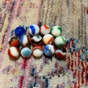 Vintage marbles white base multicolored, including one that looks like Pepsi log